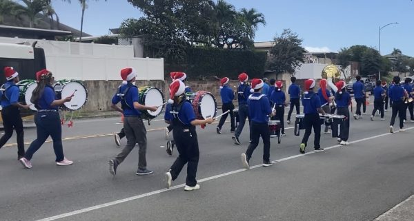 Kaiser High School Marching Band playing Christmas music as they walk down Hawaii Kai Drive