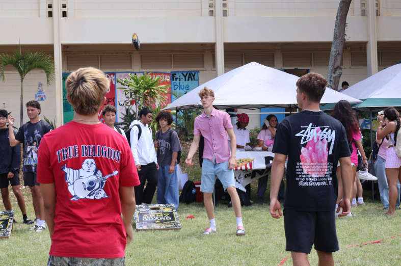 Students playing bean bag toss provided by the Army National Guard.
