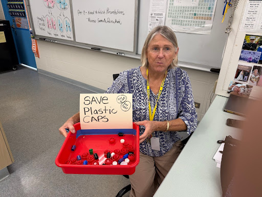Physical Science and Biology teacher Ann Lake (referred to as Ms. Lake by her students) with her accumulated bottle caps as of the end of Quarter 3